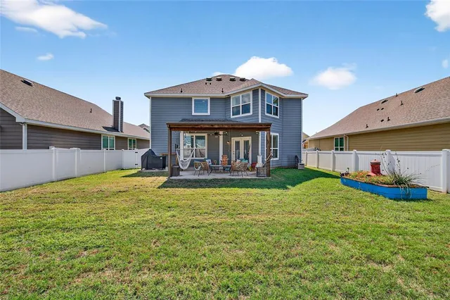 a view of a house with a yard and sitting area