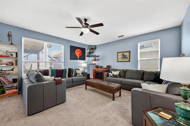 a living room with furniture and a large window