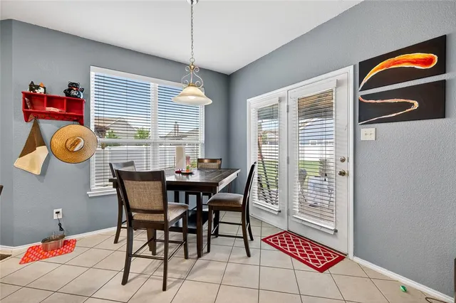 a view of a dining room with furniture and chandelier