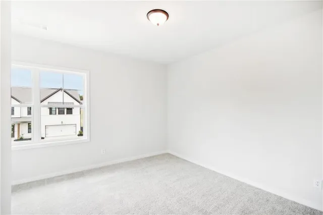 an empty room with wooden floor and a window