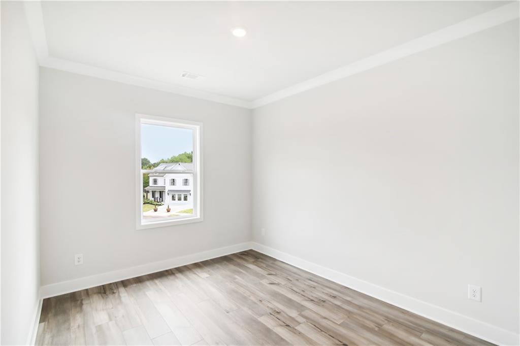 163 Wingate Drive Winder, GA 30680 - Photo 23 of 79 an empty room with wooden floor and a window