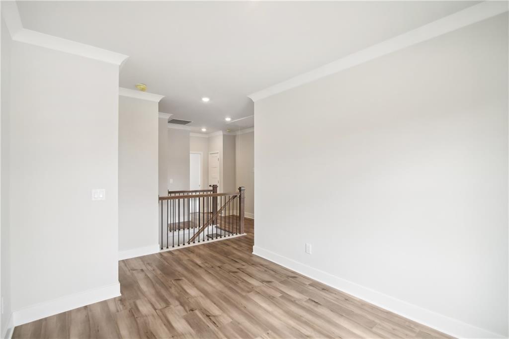163 Wingate Drive Winder, GA 30680 - Photo 24 of 79 a view of an empty room with wooden floor