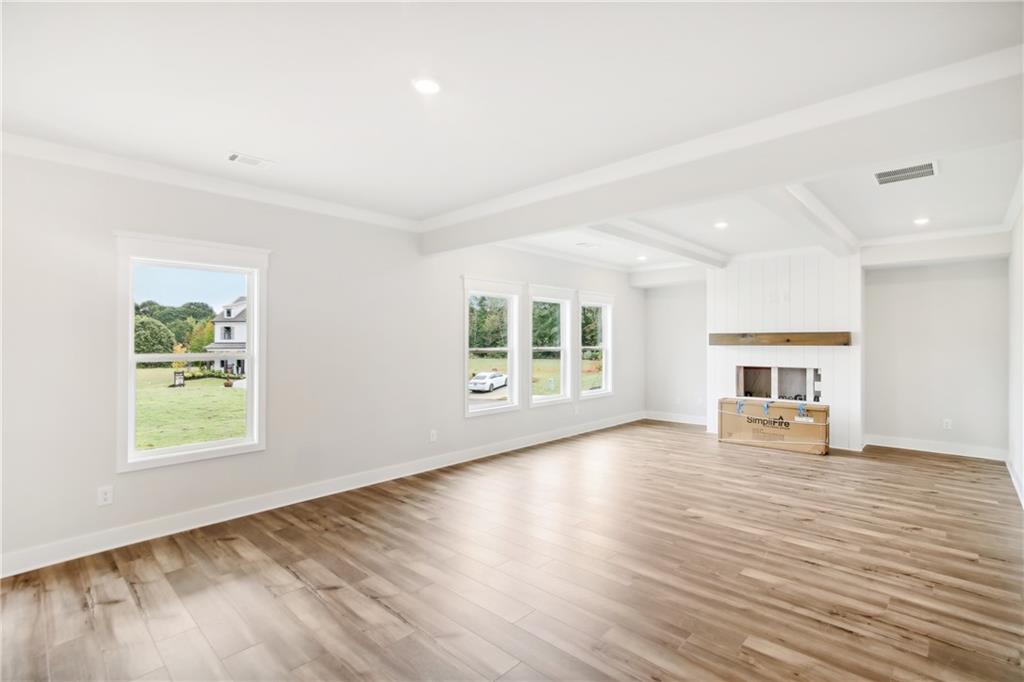 163 Wingate Drive Winder, GA 30680 - Photo 4 of 79 an empty room with wooden floor and windows