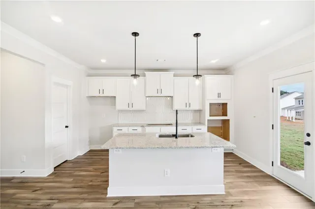 a kitchen with stainless steel appliances granite countertop a sink a refrigerator and a granite counter tops