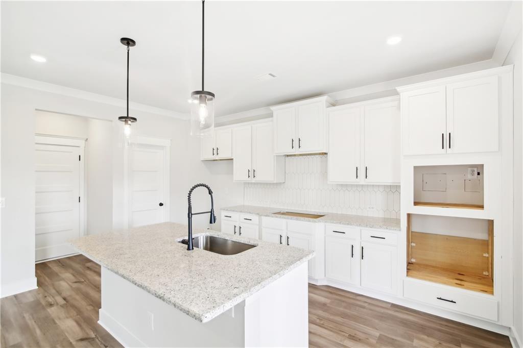 163 Wingate Drive Winder, GA 30680 - Photo 10 of 79 a kitchen with stainless steel appliances granite countertop a sink a refrigerator and a granite counter tops