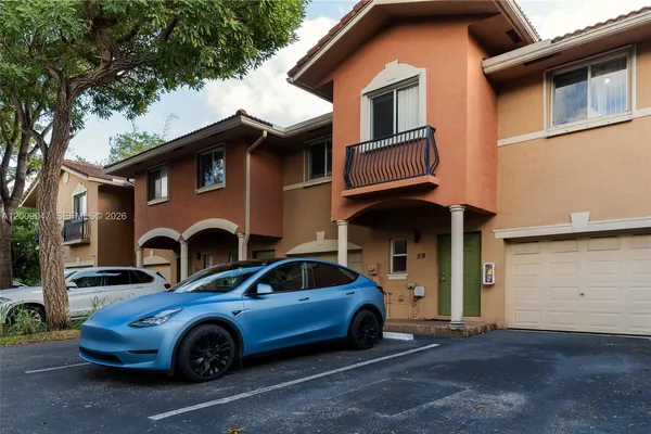a front view of a house with parking space