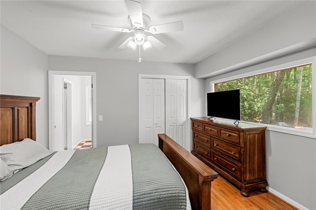 300 Whispering Falls Road Pickens, SC 29671 - Photo 16 of 41 Rich hardwood floors complement the large window framing tranquil wooded views.