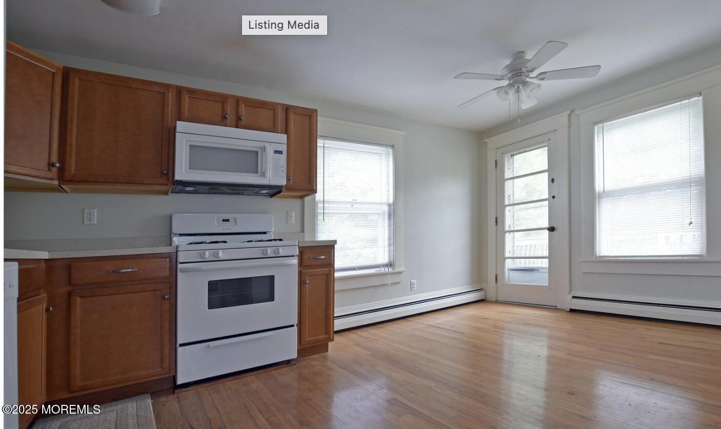 90 Pinckney Road, Unit B Red Bank, NJ 07701 - Photo 4 of 16 a kitchen with granite countertop a stove a sink and a microwave