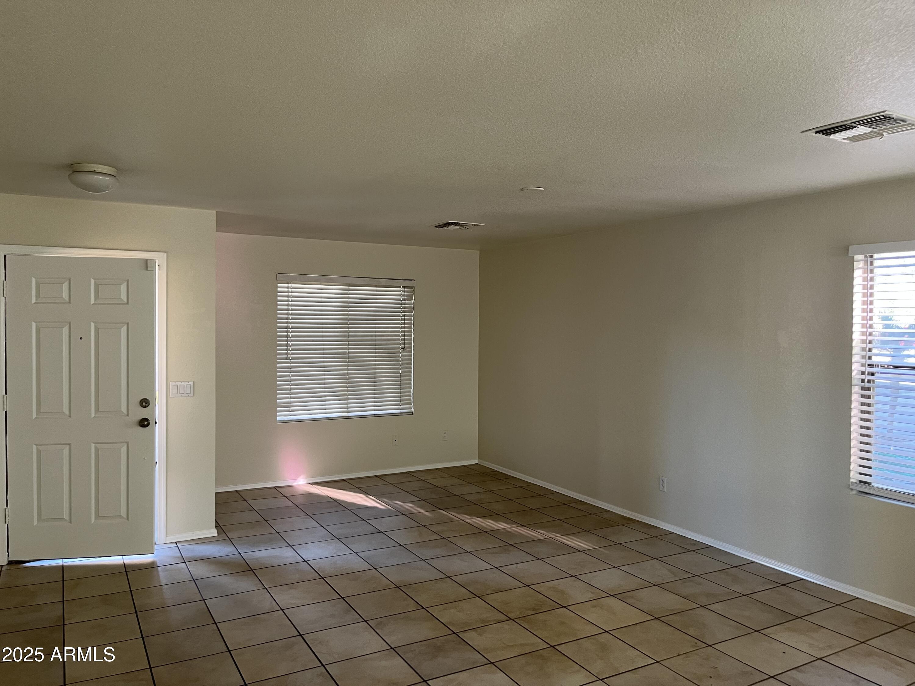 9441 West Jamestown Road Phoenix, AZ 85037 - Photo 2 of 12 a view of an empty room and window