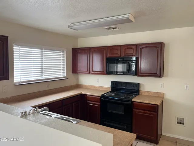 a kitchen with a sink and a stove top oven