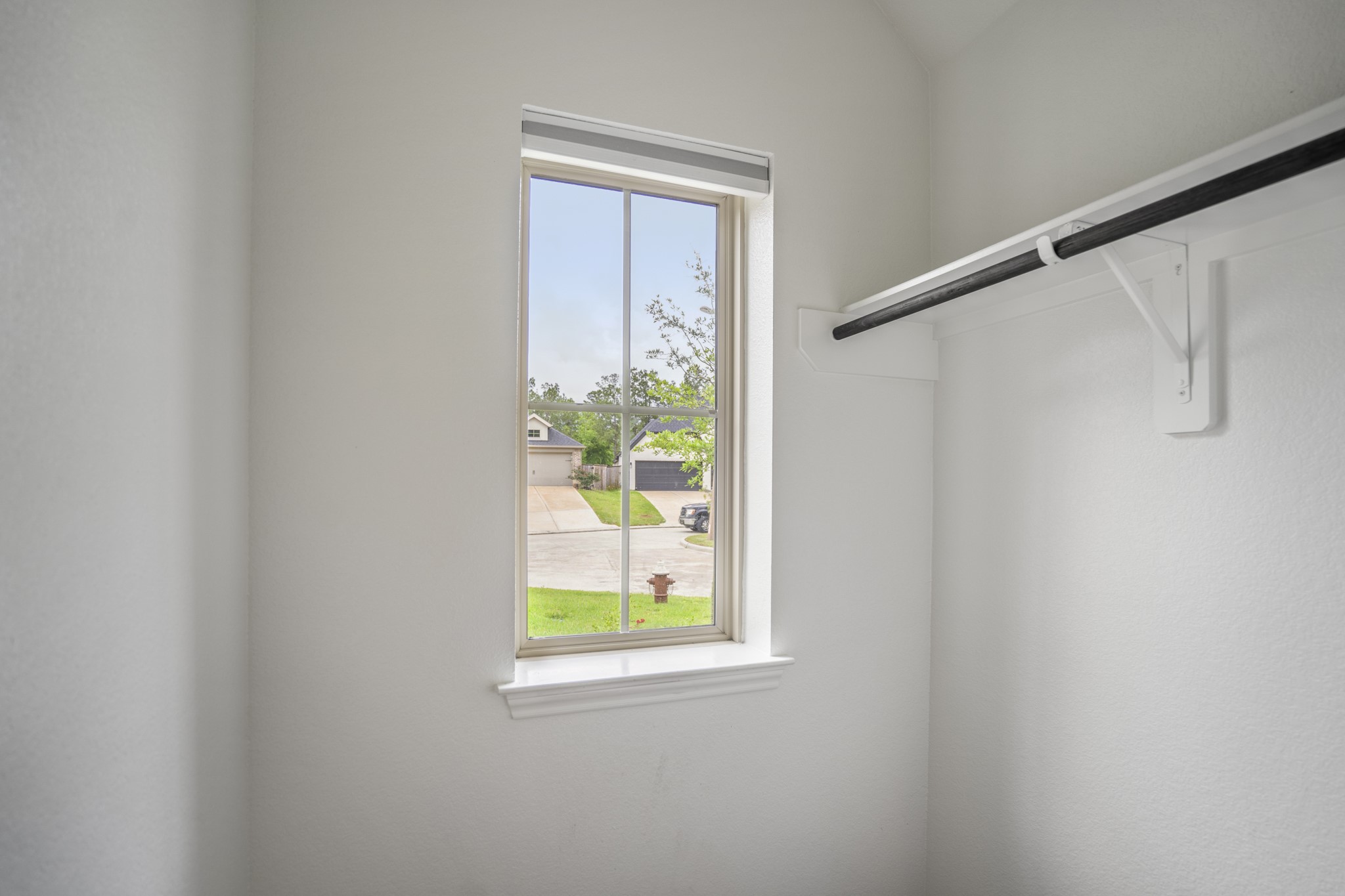 334 Topper Pines Drive Montgomery, TX 77316 - Photo 32 of 49 Inside the walk-in coat closet, a window brings in natural light while the hanging rod gives this front-entry storage more room than a standard hall closet.