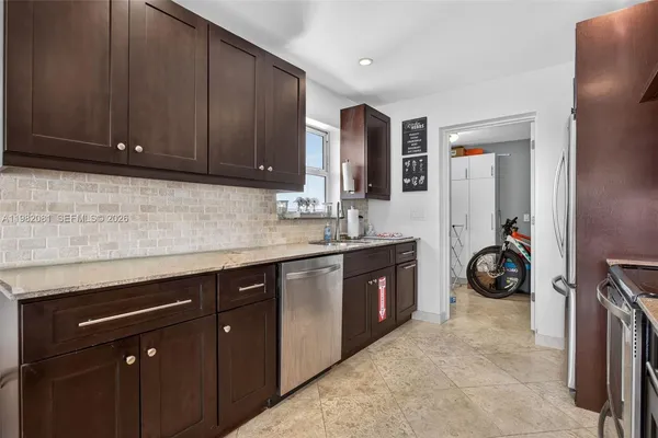 a view of a kitchen with sink and cabinets