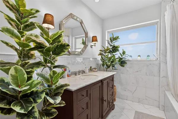 a bathroom with a bathtub a sink a toilet and a shower