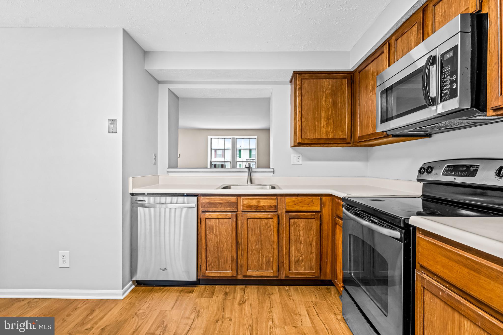 67 Dorchester Circle Marlton, NJ 08053 - Photo 7 of 25 a kitchen with stainless steel appliances granite countertop a sink a stove and microwave