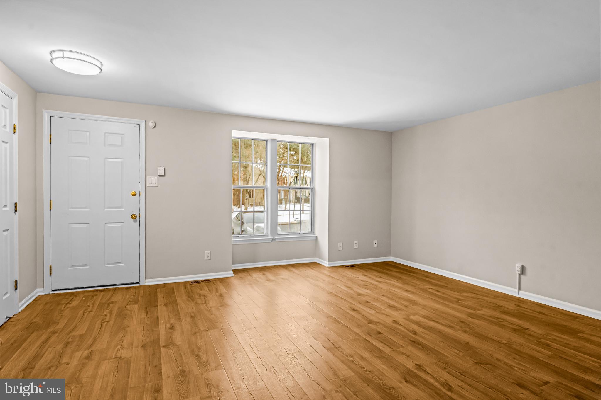 67 Dorchester Circle Marlton, NJ 08053 - Photo 9 of 25 a view of an empty room with wooden floor and a window