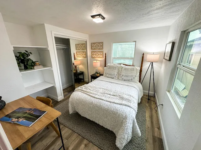 a bedroom with a bed and a window