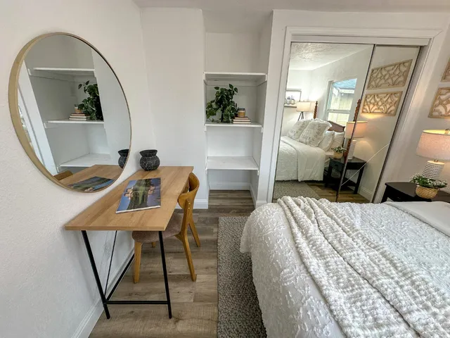 a bedroom with a bed and a mirror