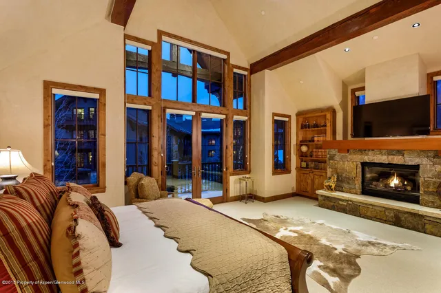 a bedroom with a bed and a fireplace