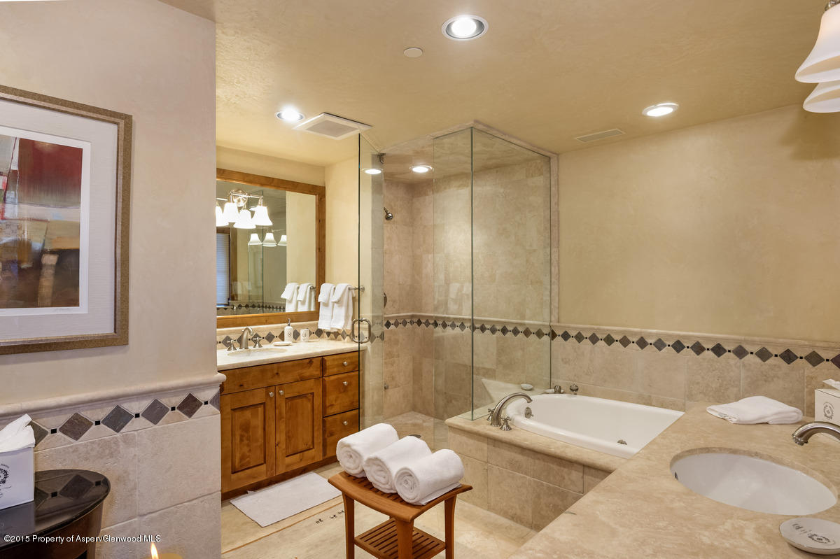 64 Prospector Road, Unit 7 Aspen, CO 81611 - Photo 19 of 23 a bathroom with a tub sink and mirror