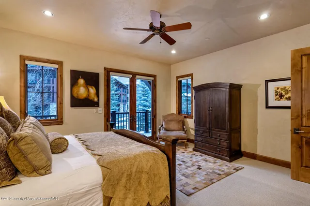 a bedroom with a bed and dresser with mirror