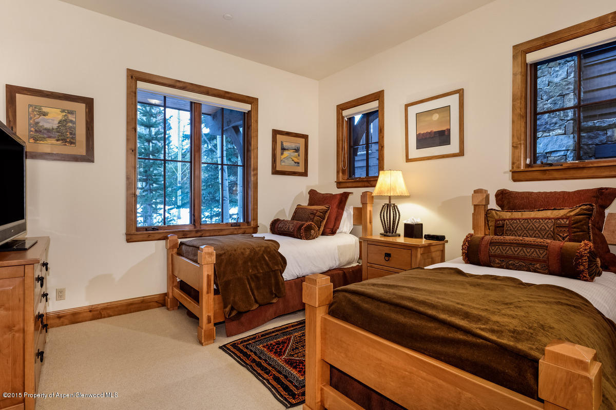64 Prospector Road, Unit 7 Aspen, CO 81611 - Photo 23 of 23 a bedroom with two beds and a couch