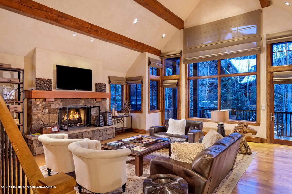 64 Prospector Road, Unit 7 Aspen, CO 81611 - Photo 5 of 23 a living room with fireplace furniture and a flat screen tv