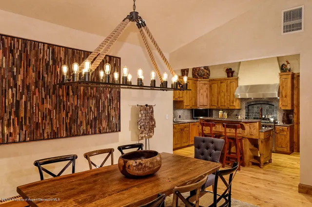 a dining room with furniture and wooden floor
