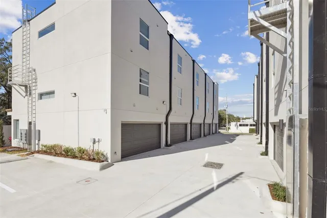 a bathroom with a bathtub shower sink vanity mirror and toilet