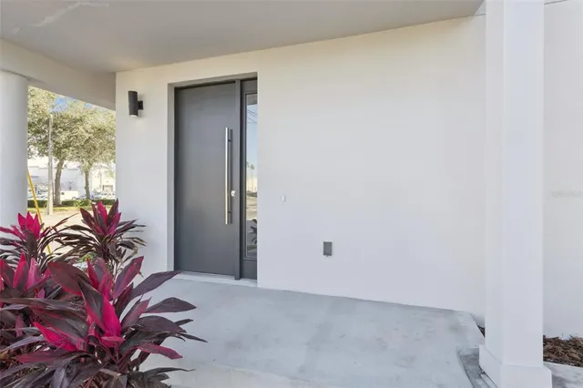 a view of a hallway with wooden floor and entryway