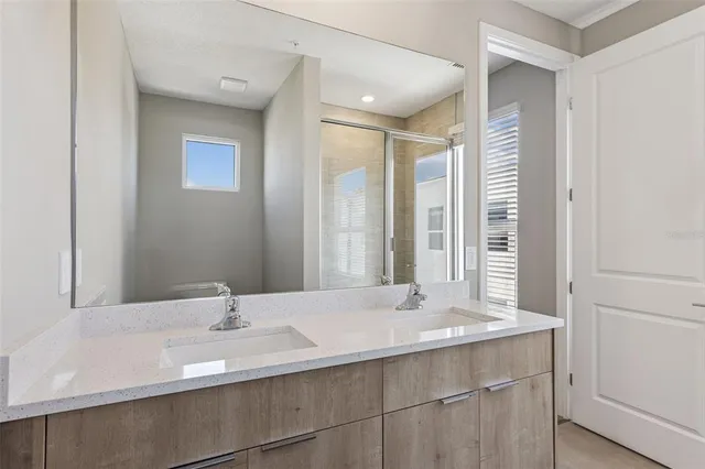 a bathroom with a granite countertop sink a toilet and a mirror