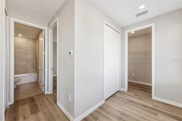 a view of a kitchen with sink wooden floor and windows