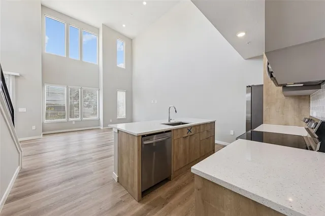 a kitchen with stainless steel appliances a microwave sink and refrigerator