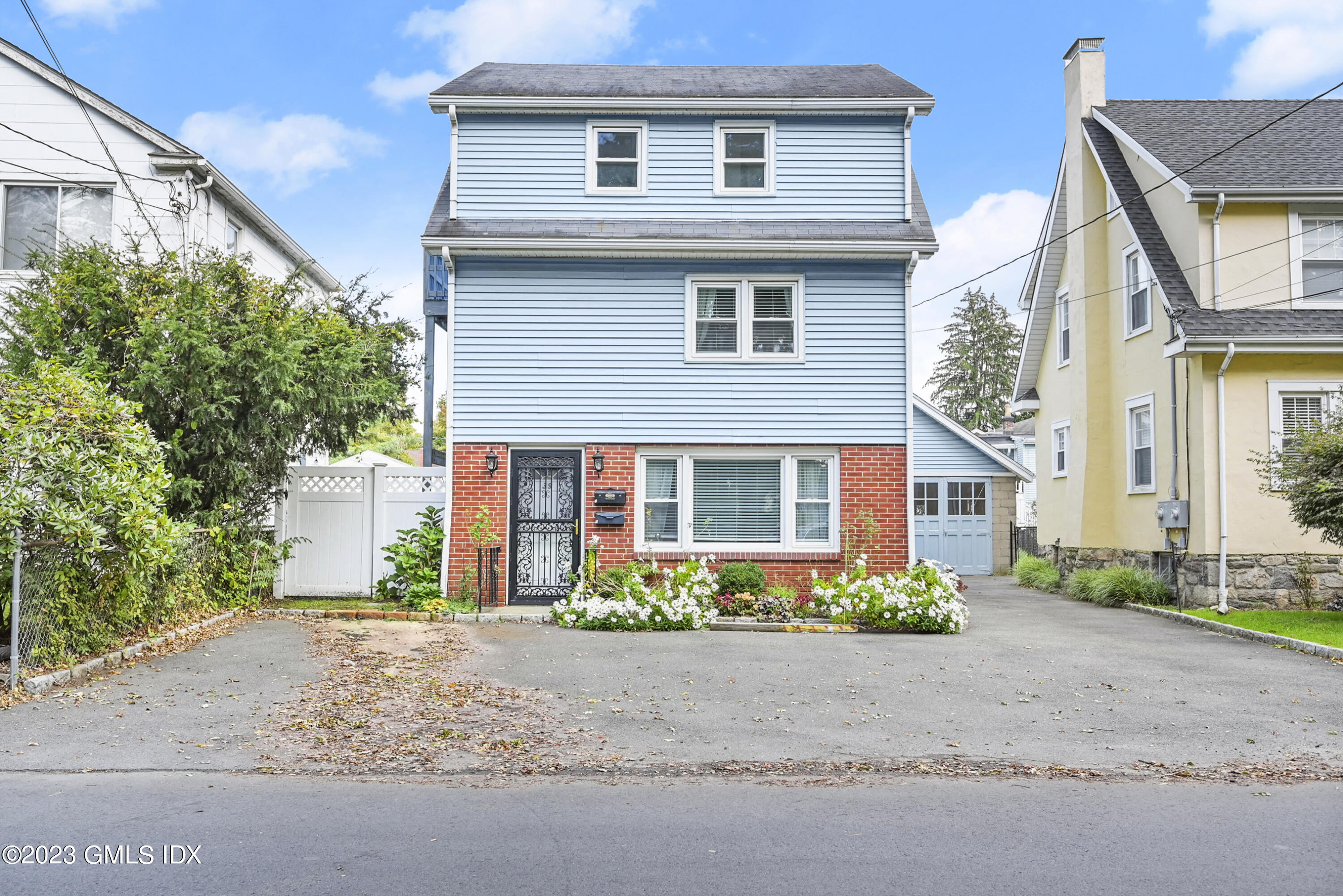 a front view of a house with a yard and a garage