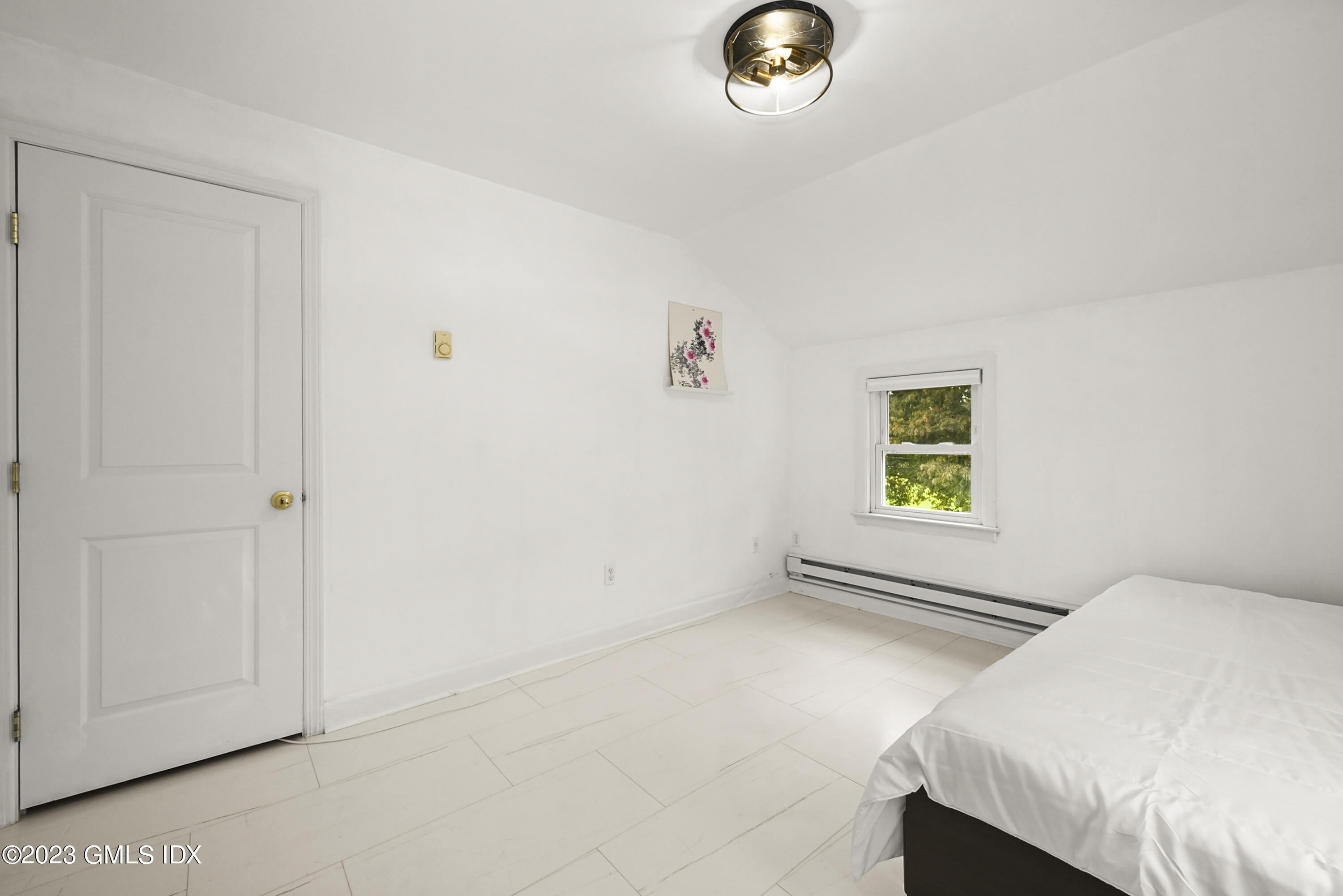 39 Bible Street, Unit 2 Cos Cob, CT 06807 - Photo 10 of 15 a bedroom with a bed and a plant