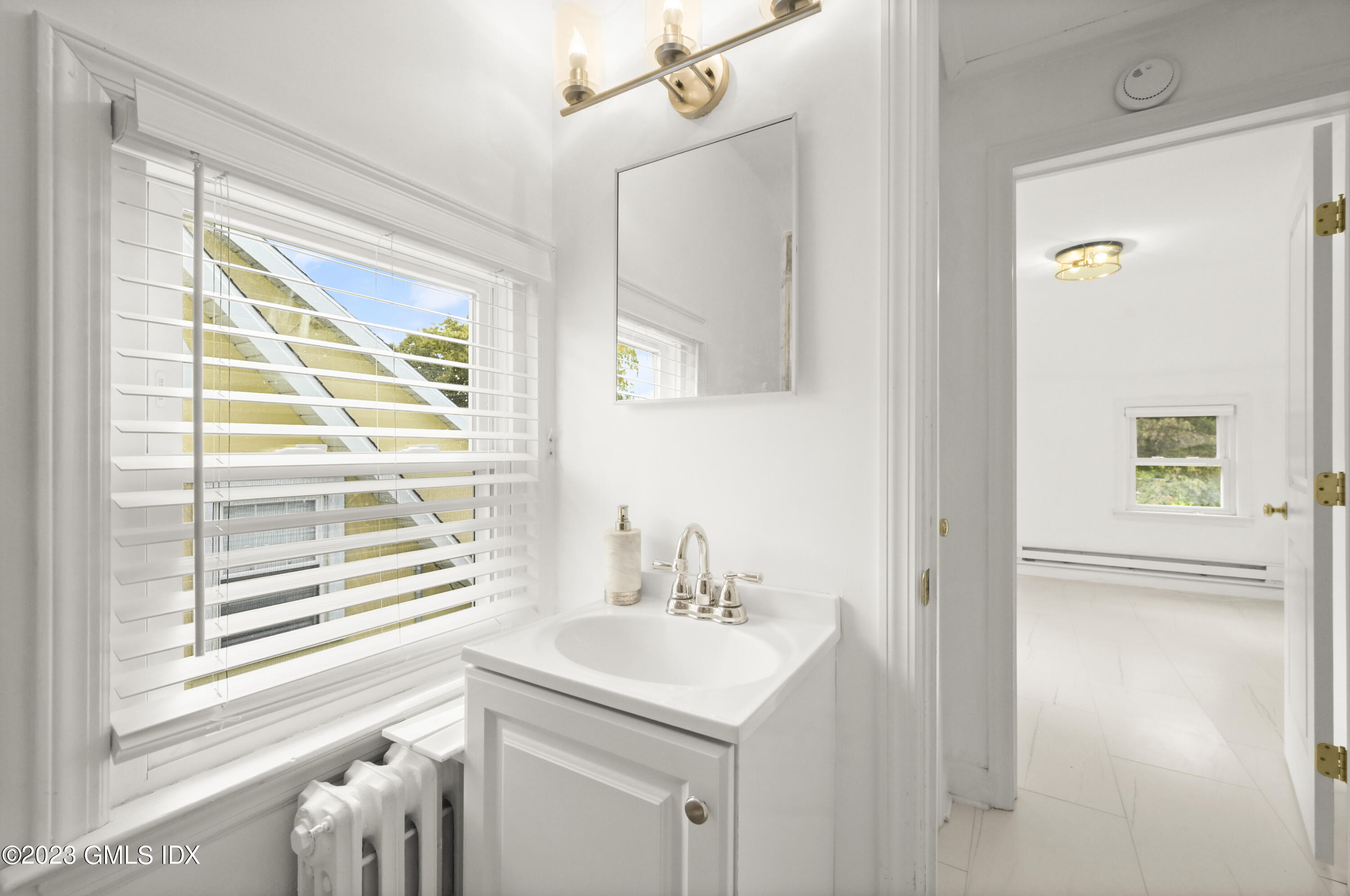 39 Bible Street, Unit 2 Cos Cob, CT 06807 - Photo 13 of 15 a bathroom with a sink a vanity and a mirror