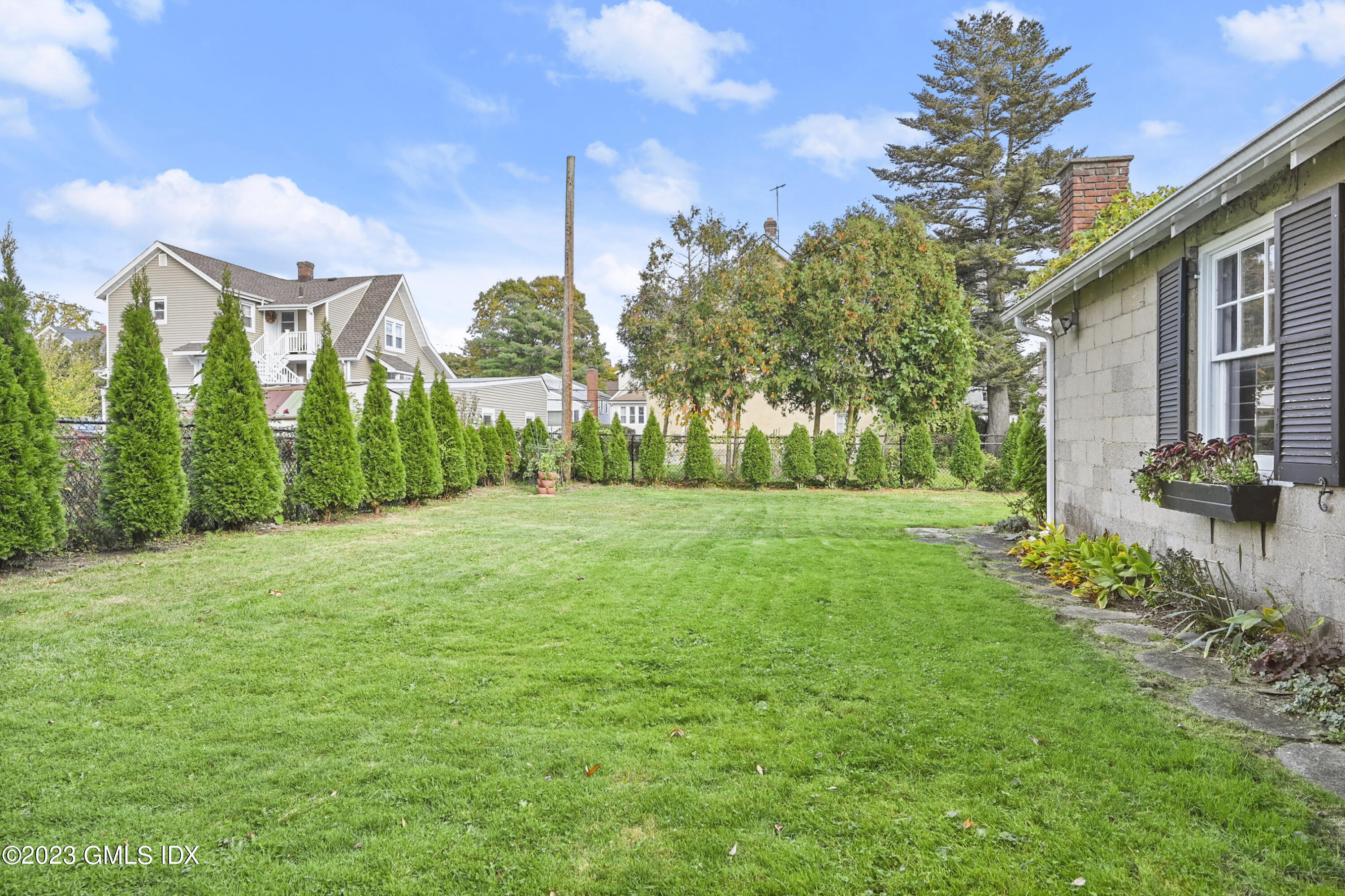 39 Bible Street, Unit 2 Cos Cob, CT 06807 - Photo 2 of 15 a view of a garden with a building in the background