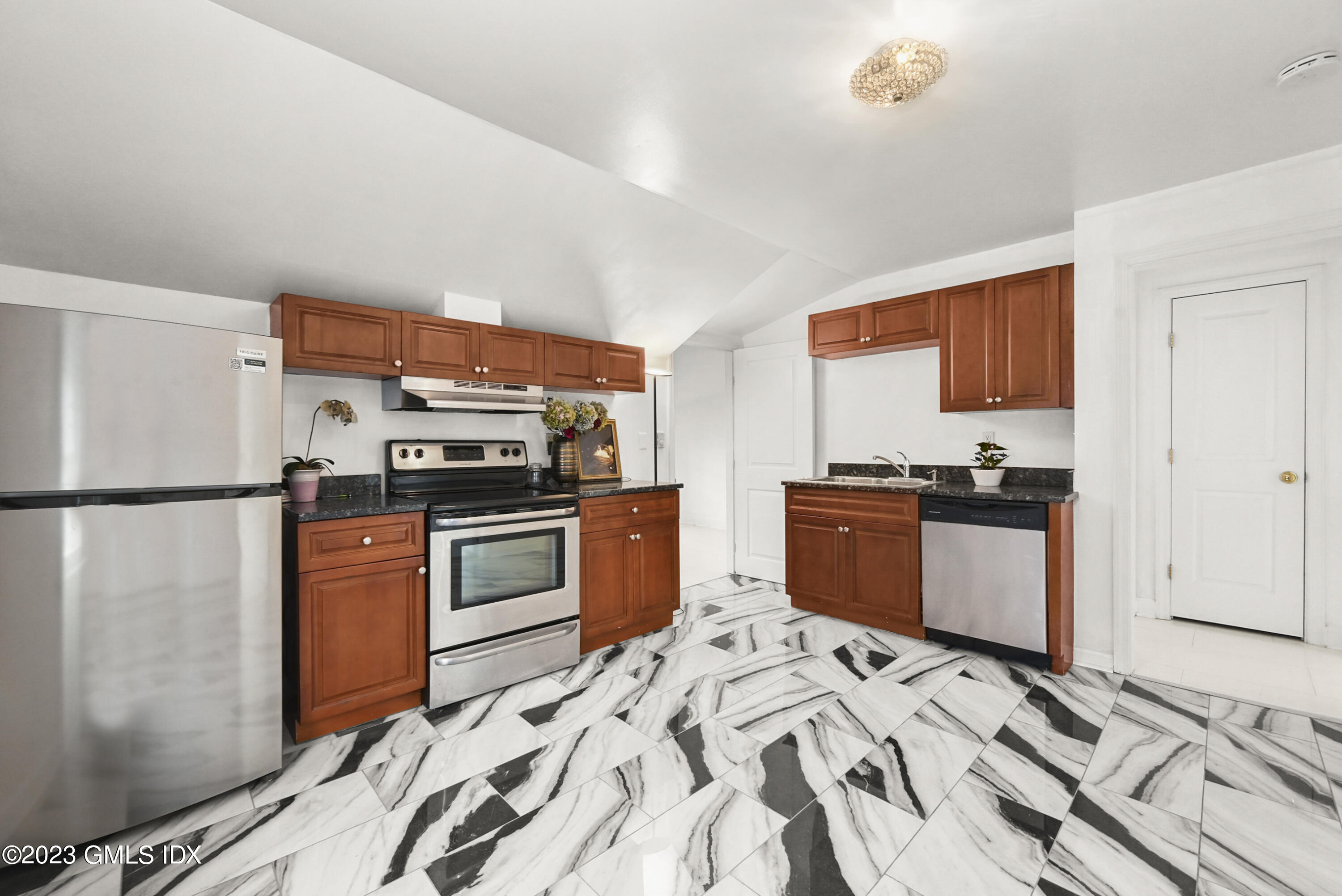 39 Bible Street, Unit 2 Cos Cob, CT 06807 - Photo 5 of 15 a kitchen with stainless steel appliances granite countertop a refrigerator stove and oven