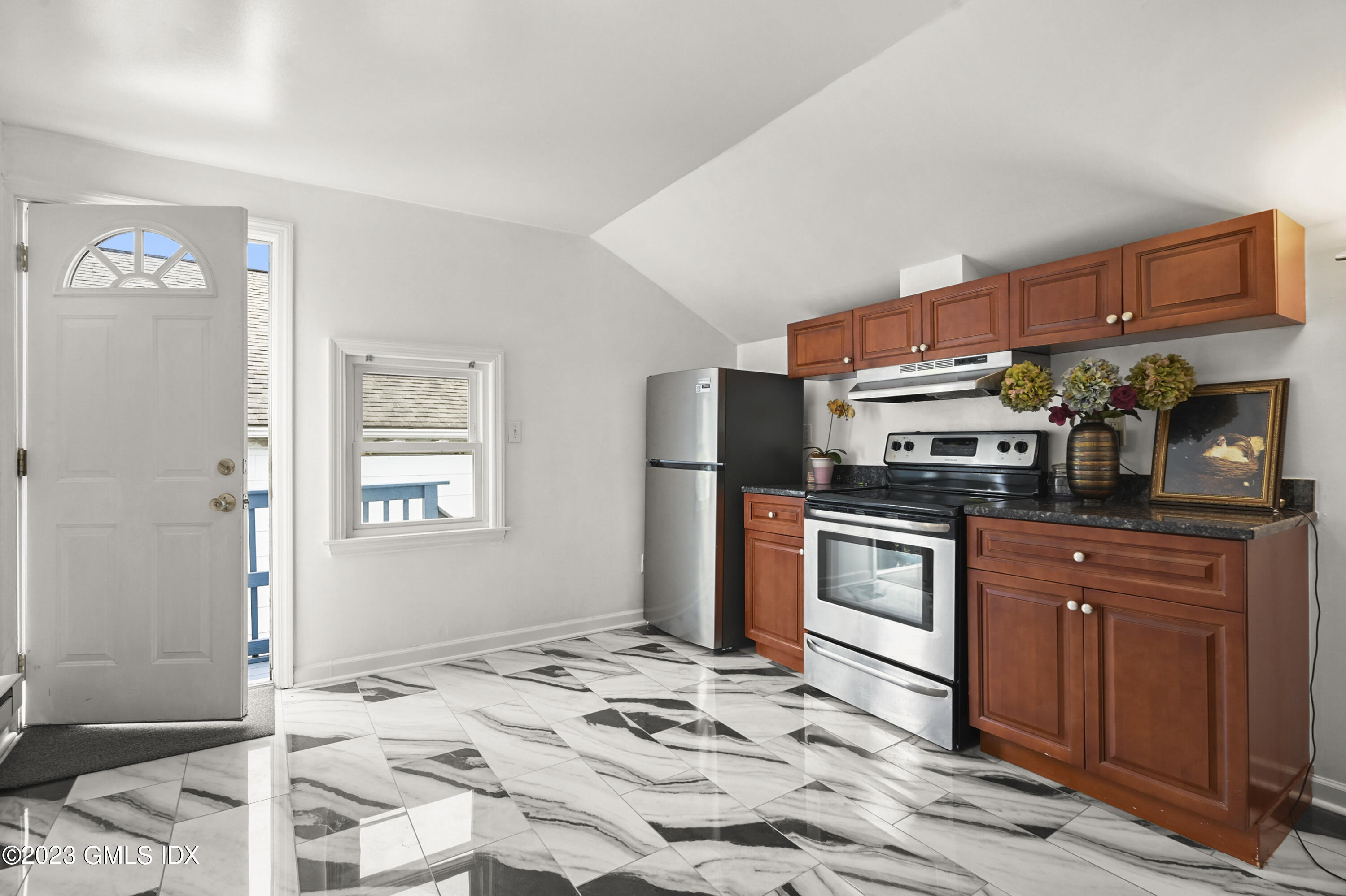 39 Bible Street, Unit 2 Cos Cob, CT 06807 - Photo 6 of 15 a kitchen with stainless steel appliances kitchen island granite countertop a refrigerator and a stove top oven