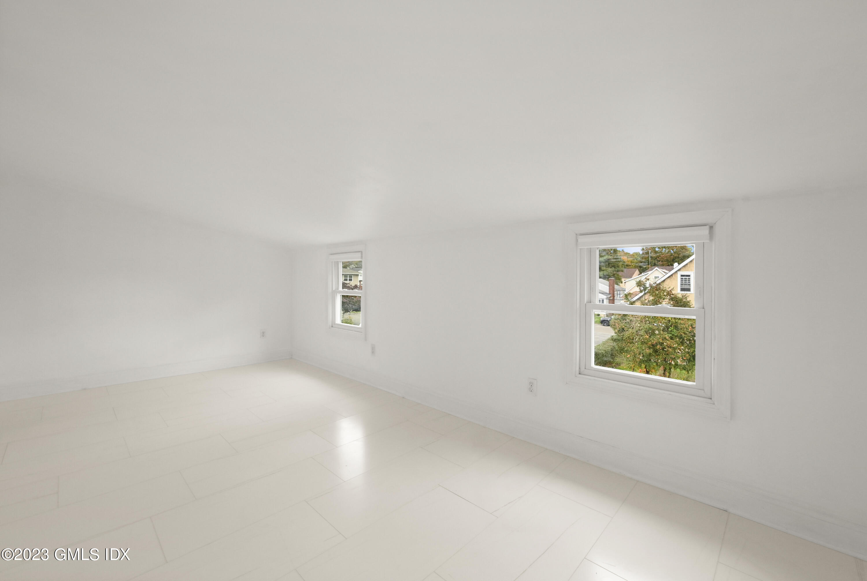 39 Bible Street, Unit 2 Cos Cob, CT 06807 - Photo 8 of 15 an empty room with windows and mirror