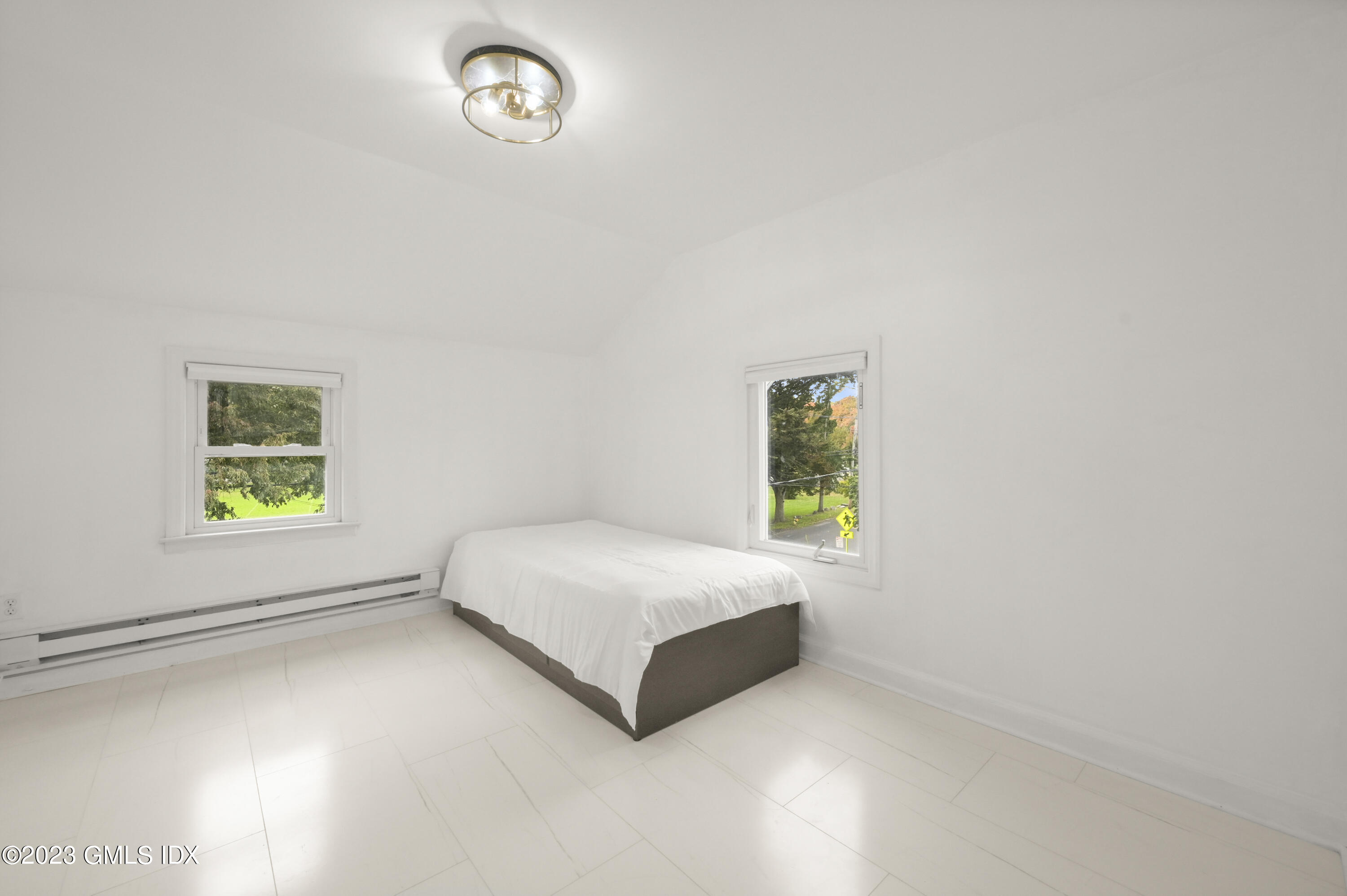 39 Bible Street, Unit 2 Cos Cob, CT 06807 - Photo 9 of 15 a spacious bedroom with a bed and a window