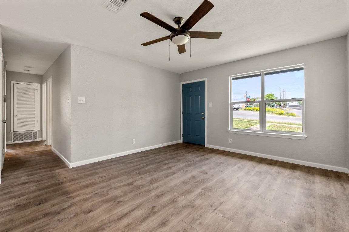 10007 Quail Valley Boulevard, Unit A Austin, TX 78758 - Photo 2 of 13 an empty room with wooden floor and windows