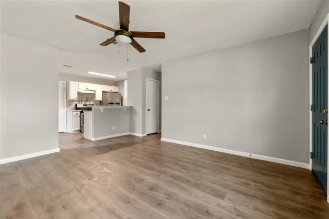 a view of a kitchen with a sink wooden floor and a window