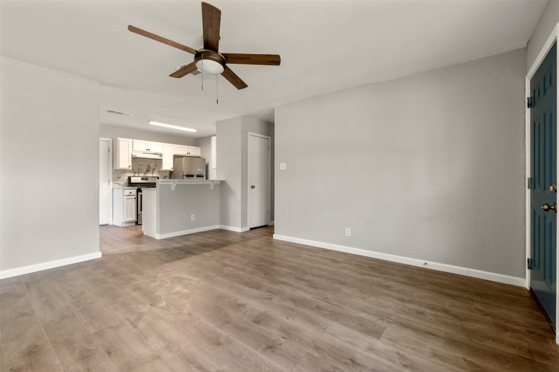 10007 Quail Valley Boulevard, Unit A Austin, TX 78758 - Photo 3 of 13 a view of a kitchen with a sink wooden floor and a window