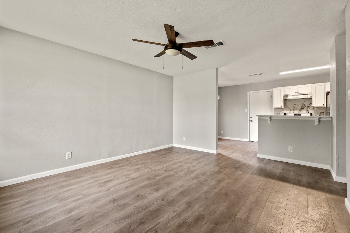 10007 Quail Valley Boulevard, Unit A Austin, TX 78758 - Photo 4 of 13 a view of a kitchen with a sink and wooden floor