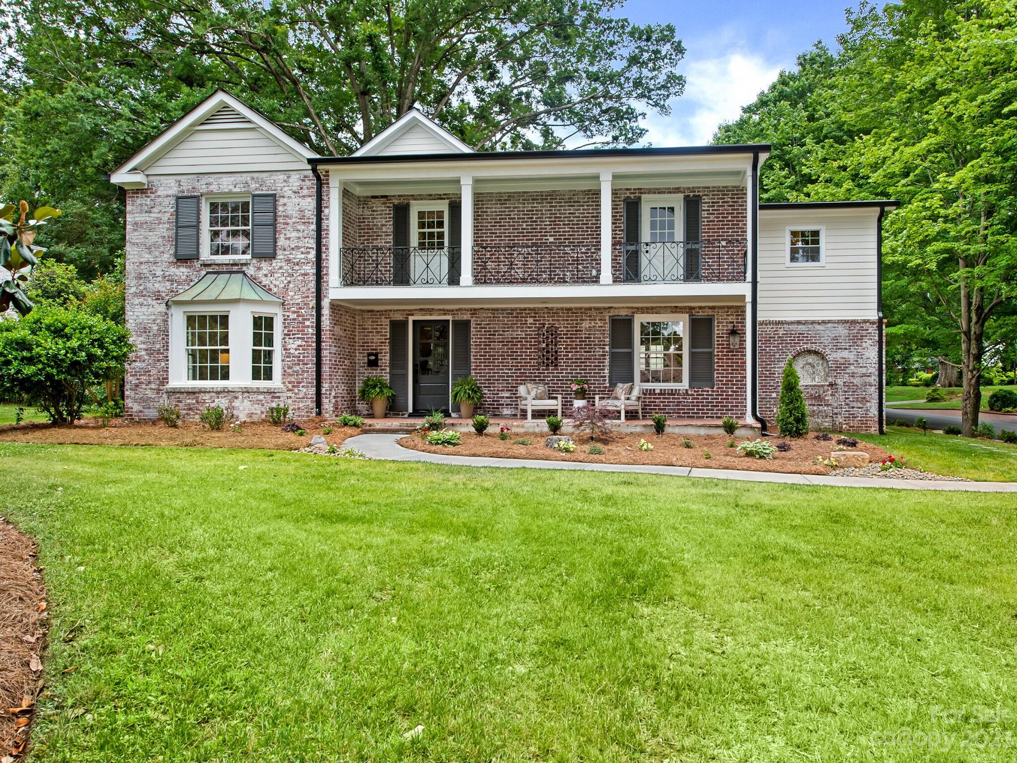 a front view of a house with yard porch and livingroom