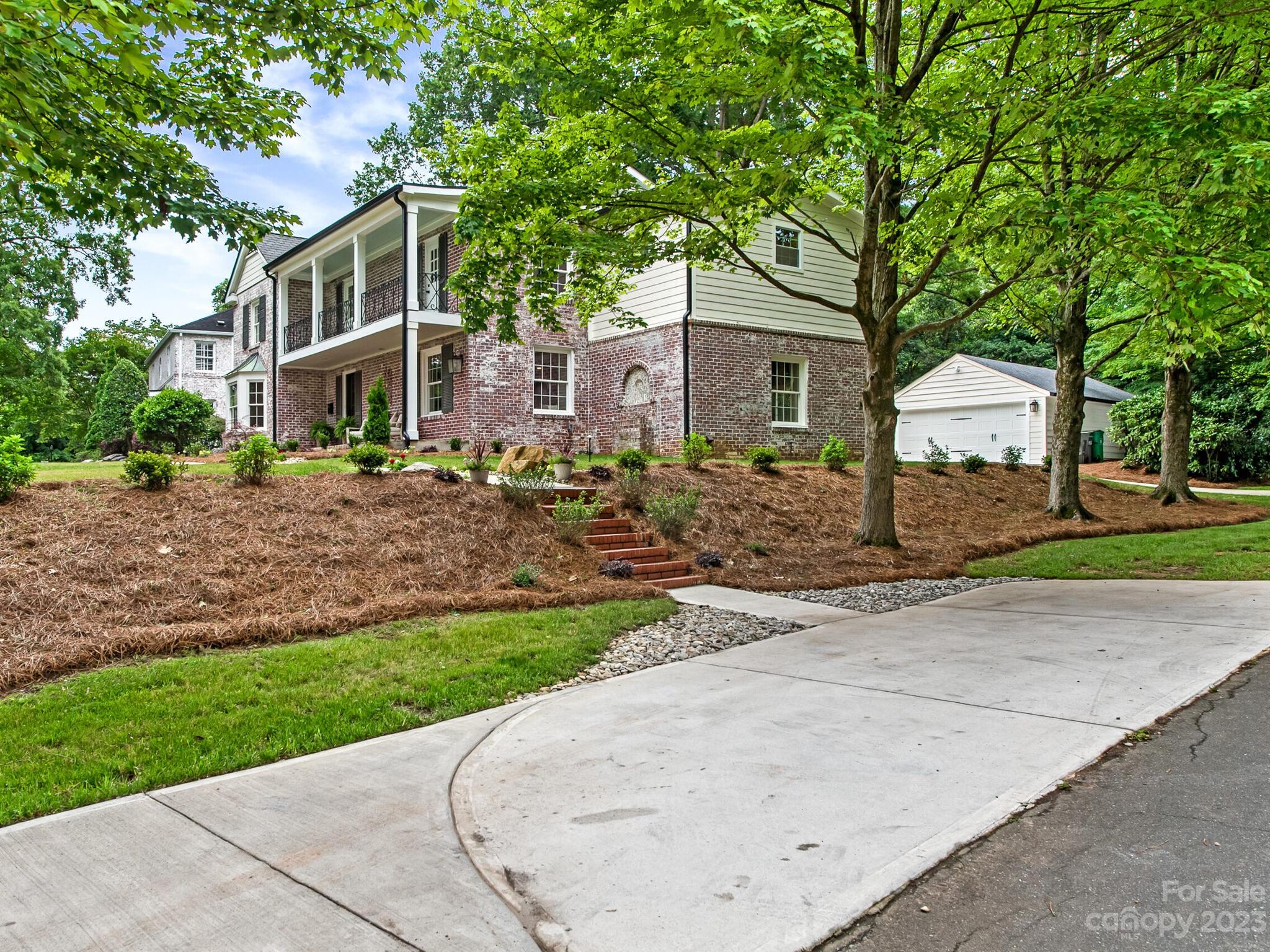1815 Harris Road Charlotte, NC 28211 - Photo 2 of 32 a front view of a house with a garden