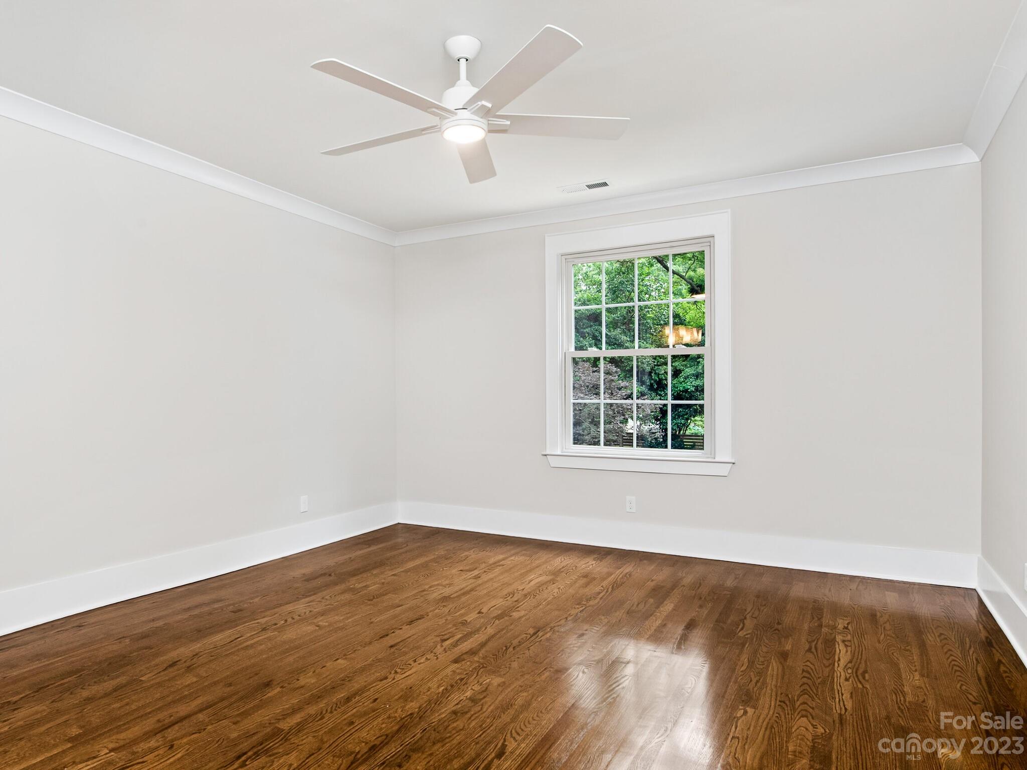 1815 Harris Road Charlotte, NC 28211 - Photo 27 of 32 an empty room with wooden floor and windows