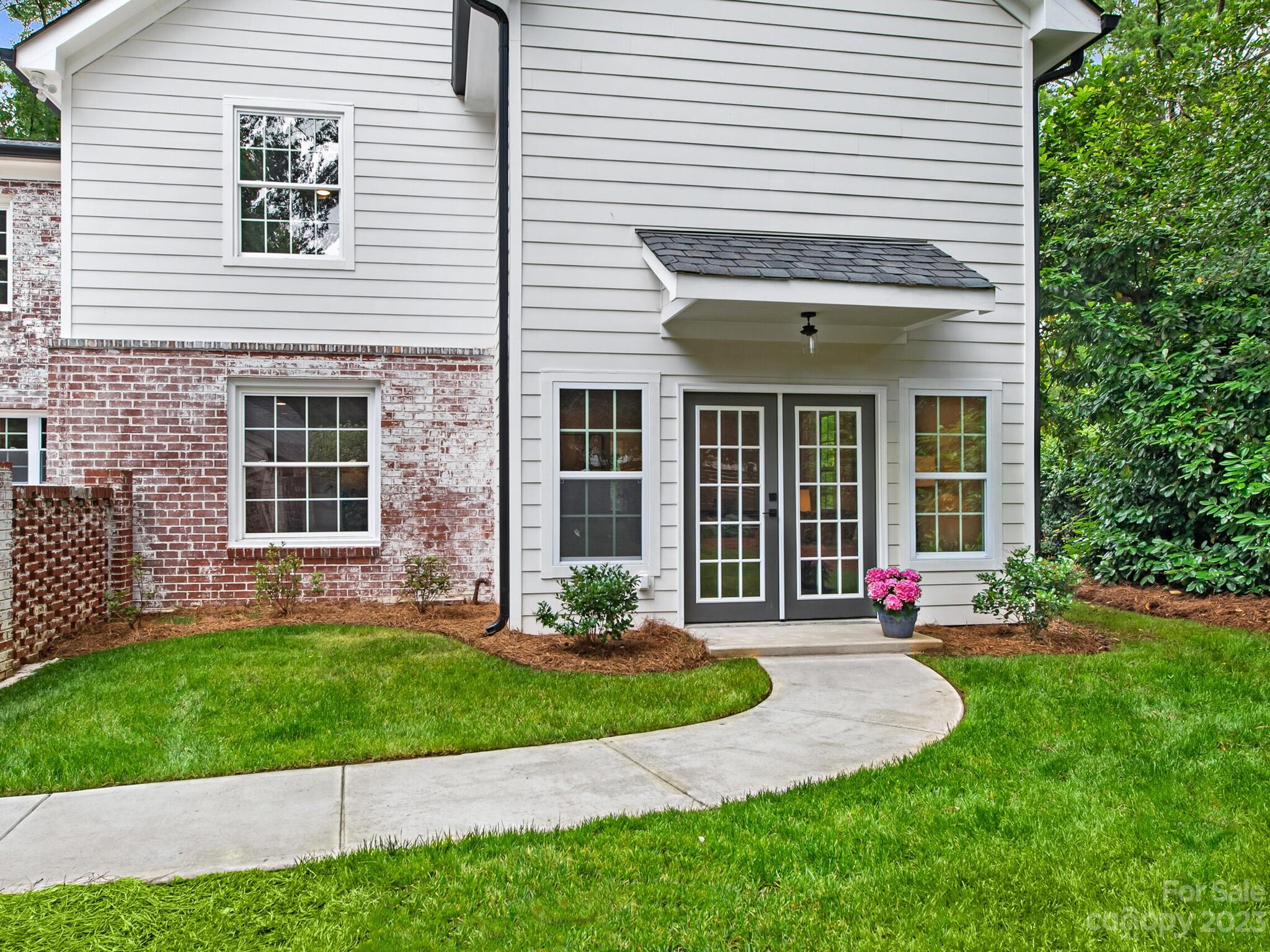 1815 Harris Road Charlotte, NC 28211 - Photo 30 of 32 a front view of a house with a yard and table and chairs