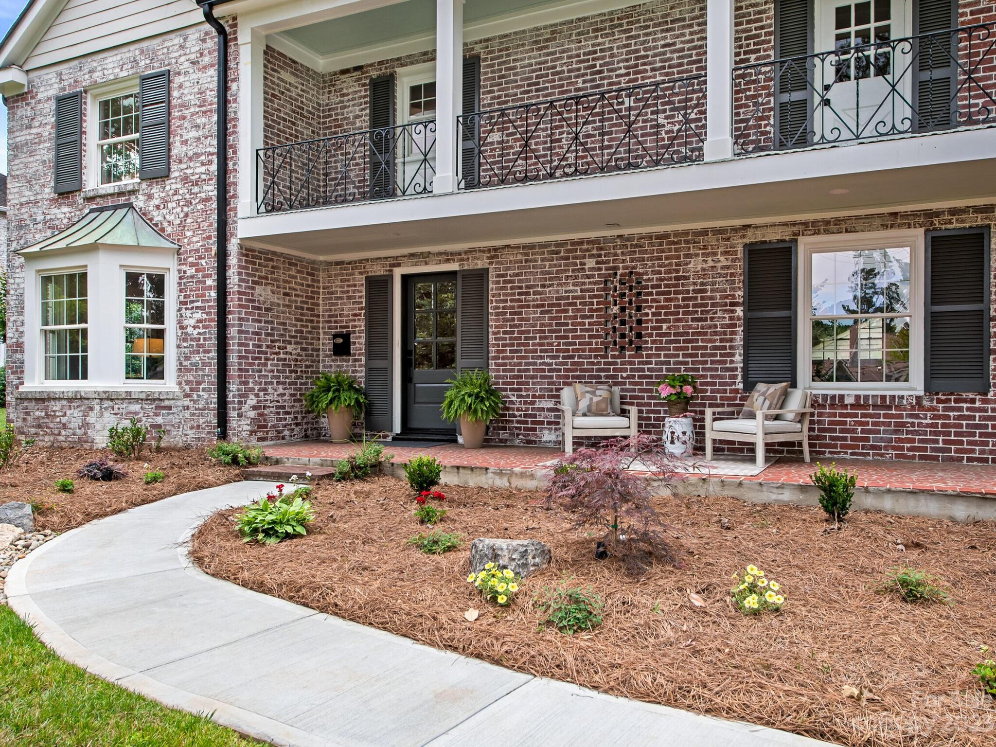 1815 Harris Road Charlotte, NC 28211 - Photo 3 of 32 front view of a brick house with potted plants