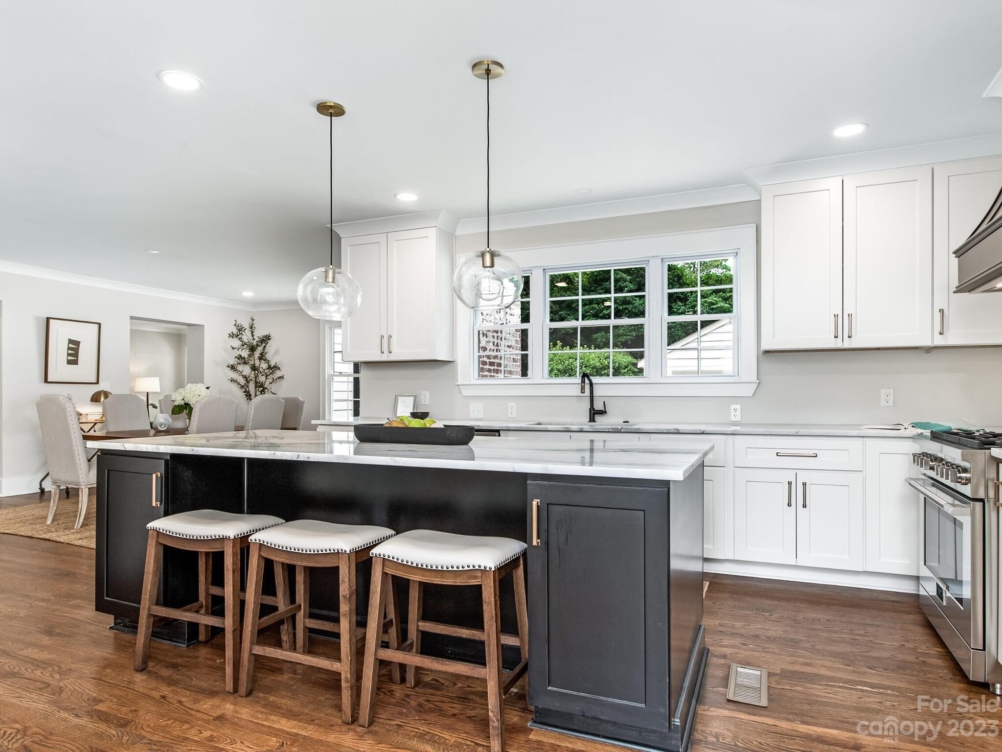 1815 Harris Road Charlotte, NC 28211 - Photo 5 of 32 a kitchen with a table chairs sink and cabinets